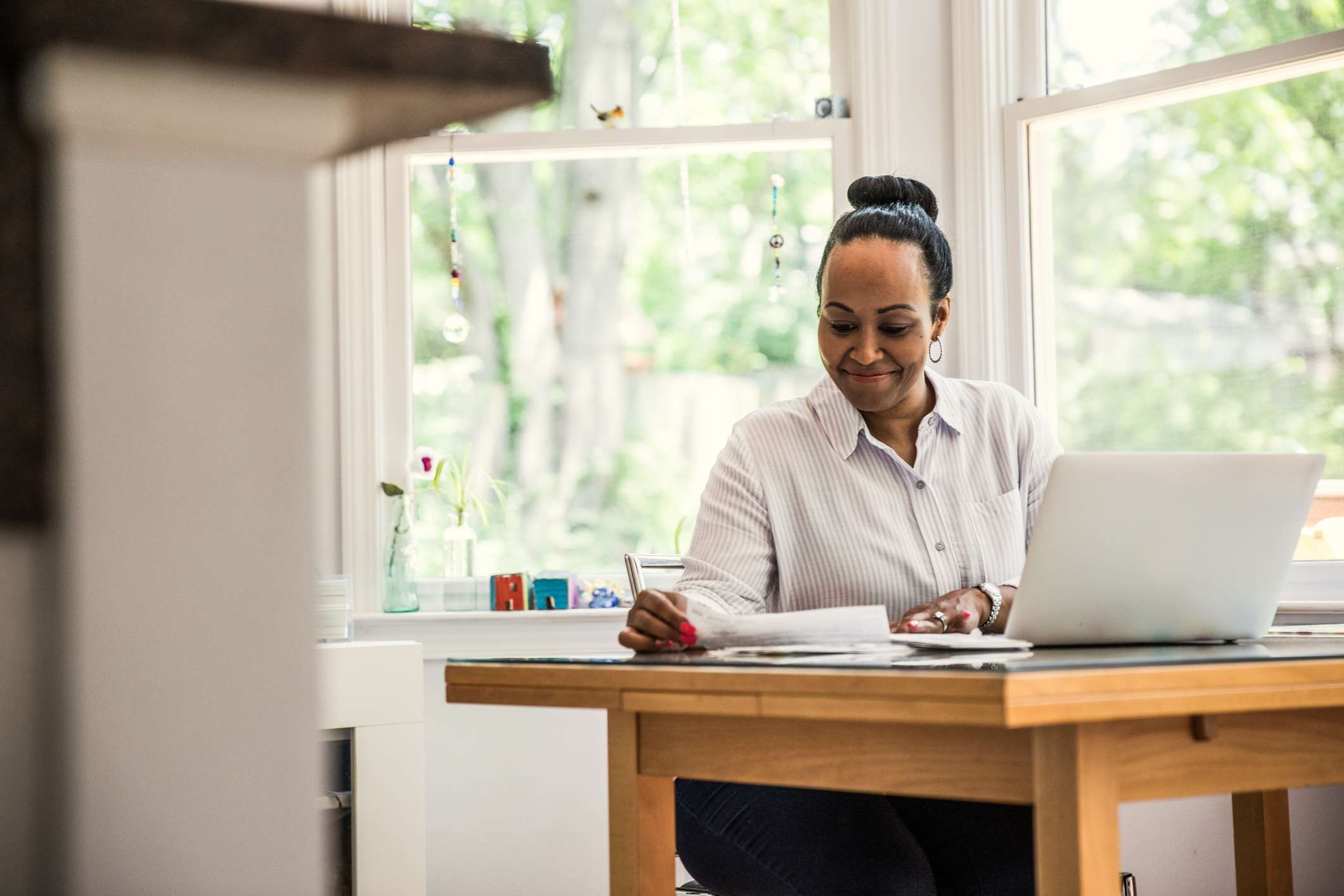 A woman is working at her desk.