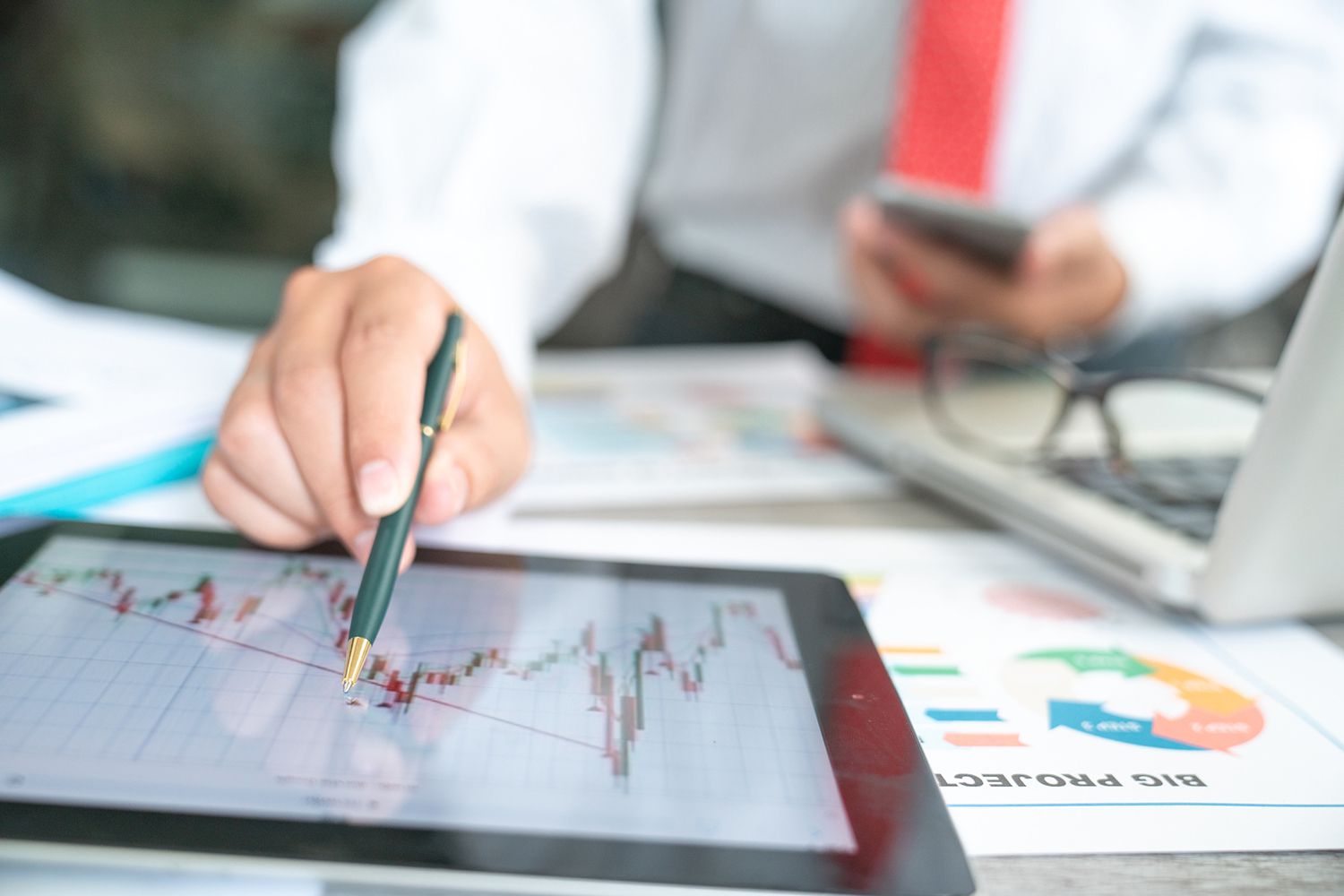 Businessman Using a Mobile Device to Check Market Data