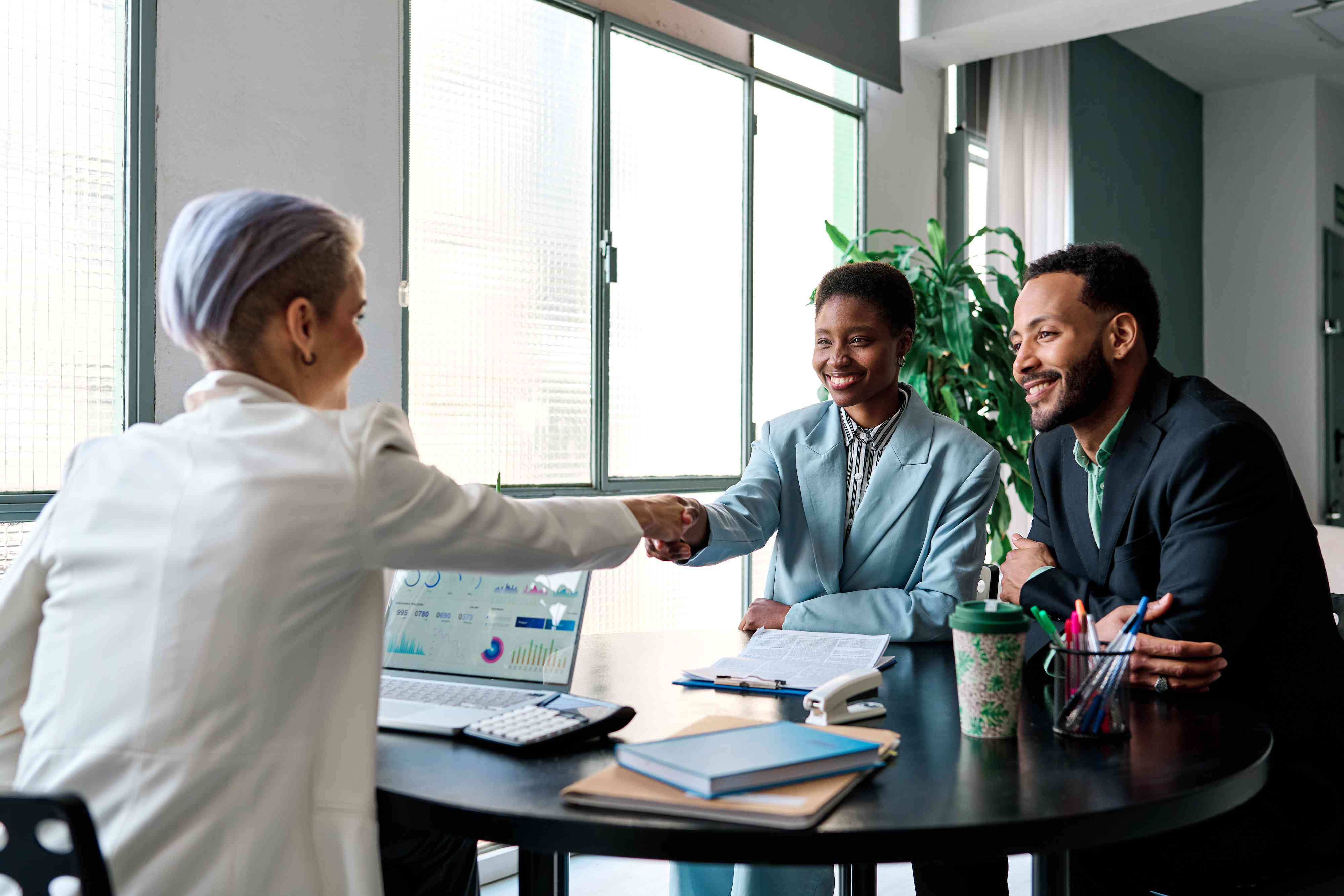 Businesswoman shaking hands to close a deal with clients in the office